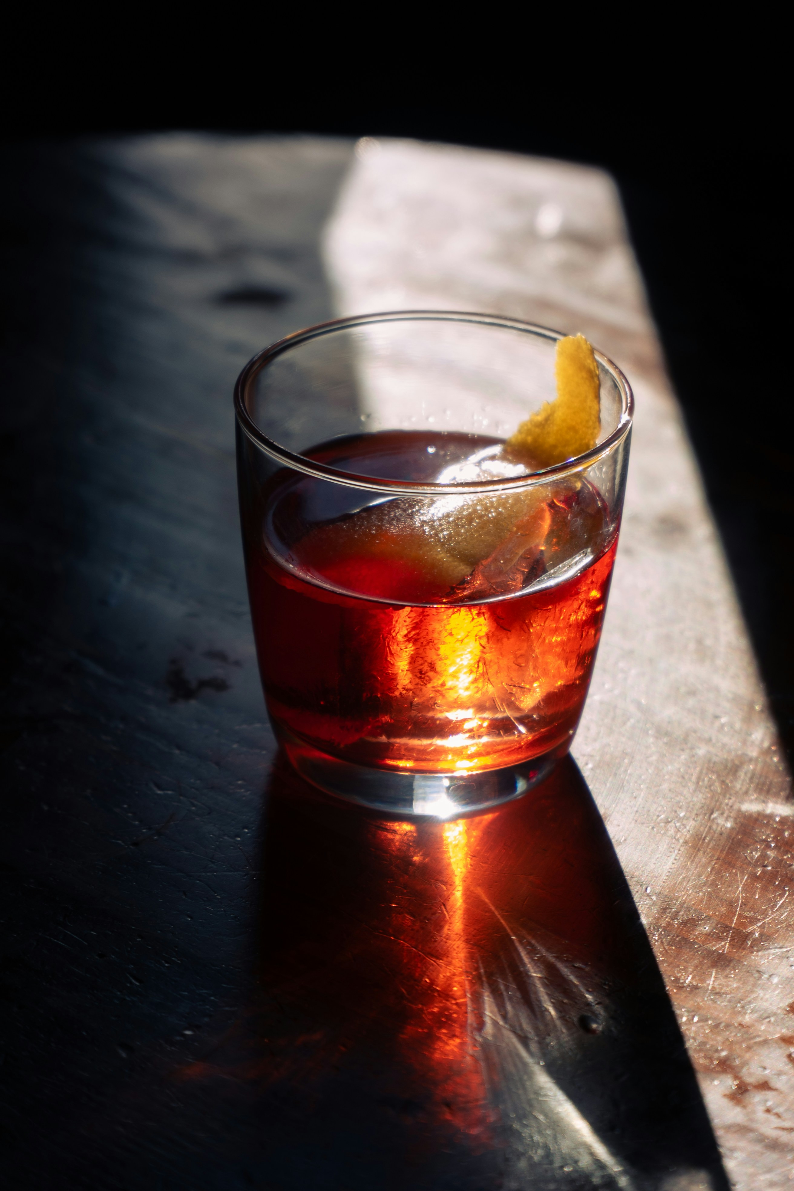 A negroni on a dark bar surface